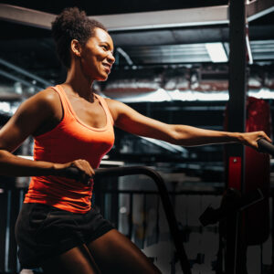 fitness-female-using-air-bike-for-cardio-workout-a-HGX6EBH